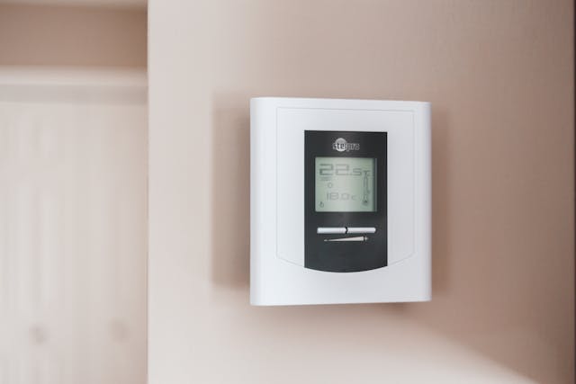 white-thermostat-hanging-on-the-wall